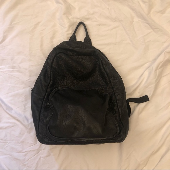 bdg leather backpack Commuter Bag BDG Mira belted bag in a crescent bag silhouette crafted from soft faux leather accented with antiqued hardware for an edgy touch to your look BDG Classic Canvas Backpack |